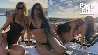 Kim and Khloe Kardashian straddle each other in bathing suits on Cabo vacation