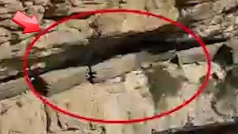 There appears to be a coffin-like object inside the cliff...