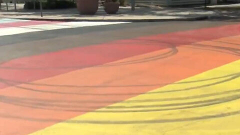 Police Hunt Man Who Did Donuts On a Pride Flag Mural in the Street