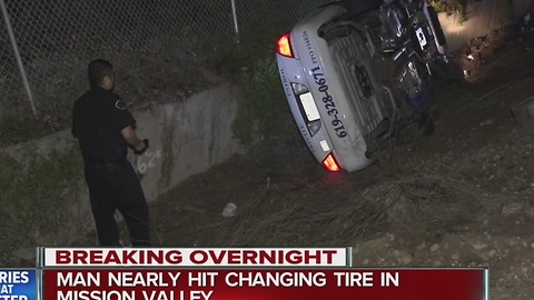 Security guard flips car after losing control on wet pavement, nearly hits man changing tire