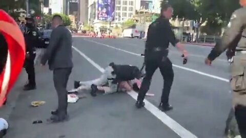 Secret Service takes down a woman protester during Potus motorcade