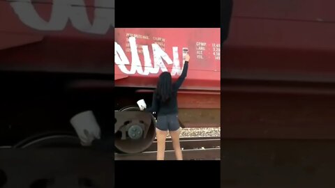 GIRL GRAFFITI BOMBING A TRAIN #shorts