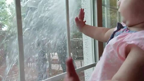Tot Girl Gets Startled When Her Dad Sprays Window She Stares Out