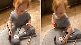 Precious Toddler Adorably Applies Makeup To Stuffed Animal