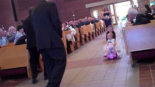 Little Girl Enjoys A Toy Car Ride In The Middle Of The Wedding