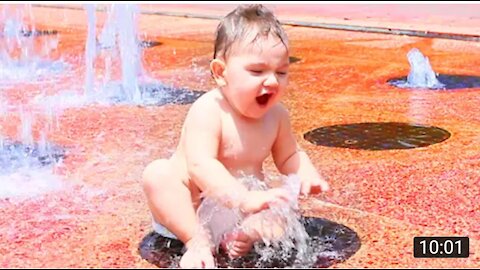 Funny baby playing with water.video