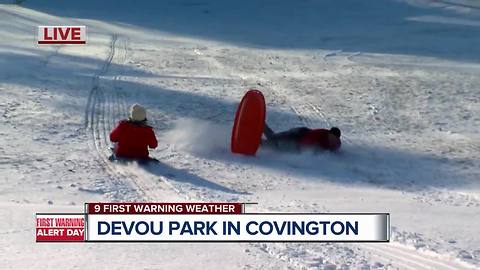 Kathrine Nero shows T.J. Parker who's boss on Devou Park sledding hill