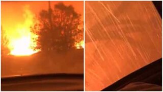Men run to escape a massive fire in California