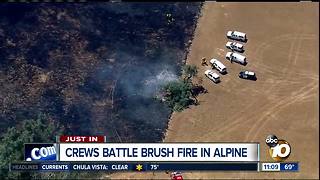 Crews battle brush fire in Alpine