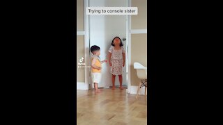 Baby boy tries to console crying sister