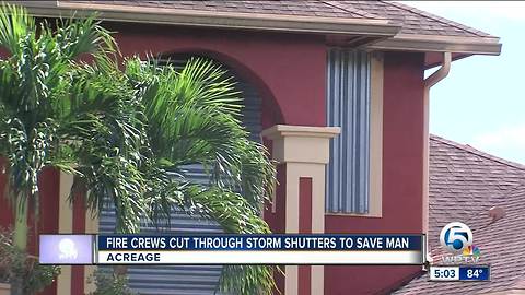 Firefighters cut into storm shutters to save man from burning home