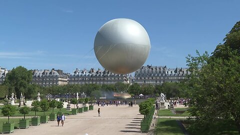 Visitors marvel at the Olympic cauldron in Paris