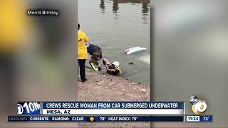 Crews rescue woman from submerged car