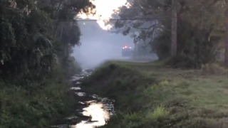 Firefighters watching small brush fire