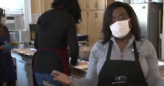 Woman making pasta for others