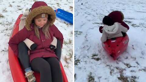 Kids on sled get airborne after hitting bump at fast speed