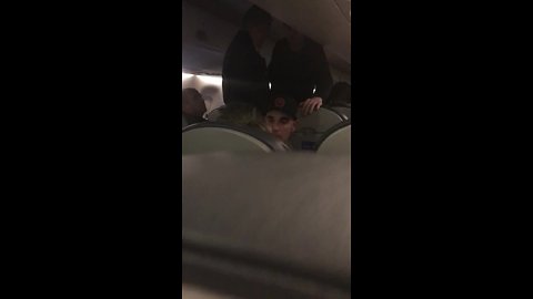 Fellow passenger helps woman during flight