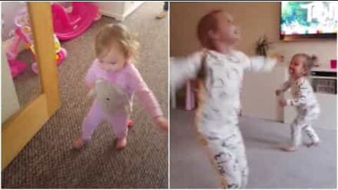 Girl helps her sick little sister take her first steps