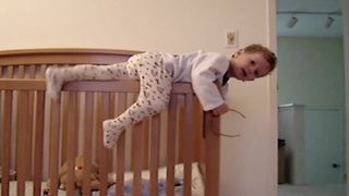 "A Tot Boy Tries to Escape A Crib but Fails"