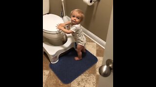 Baby boy shuts bathroom door for privacy