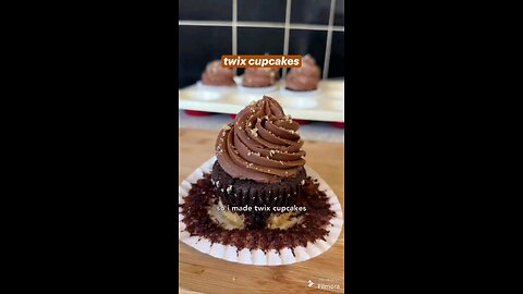 chocolate cupcakes with a shortbread base, filled with dulce de leche and topped with whipped milk