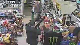 WATCH: Masked robber fires shot into store ceiling before stealing cash