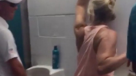 Drunk Female Dolphins Fan Stumbles into Men's Bathroom, PEES in the Urinal!