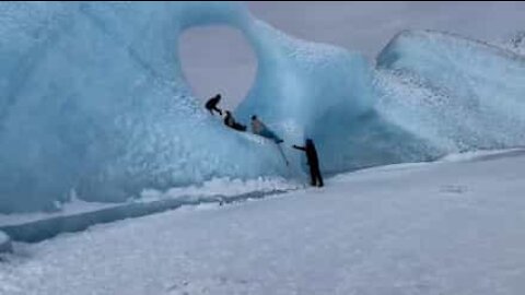 Tourist climb unusual ice formation in Alaska