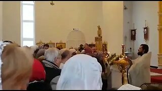 Orthodox Priest Uses A Hose To Spray Congregation With Holy Water