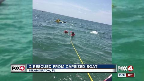Coast Guard rescues two from capsized boat