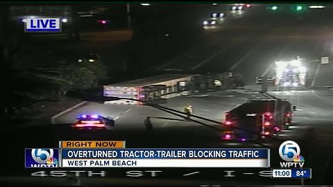 Overturned tractor-trailer blocking traffic