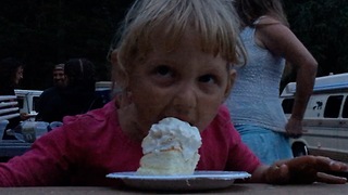 Adorable Little Girl Enjoys Birthday Cake