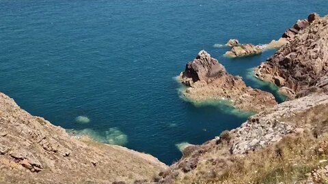 2 minutes of calm relaxation watching sea rippling among cliffs and rocks with soothing music.