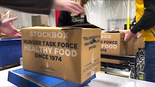 Volunteers work to box hundreds of meals for those in need