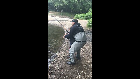 Father son reel in river monster