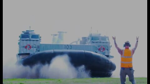 Landing Craft Air Cushion transports a CH-46 Sea Knight helicopter