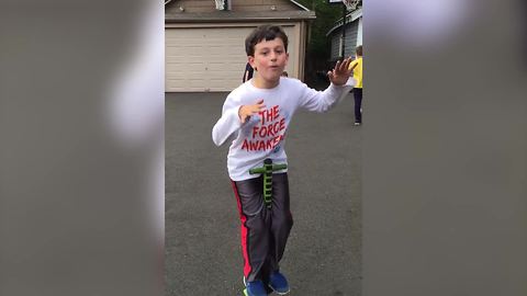 A Little Boy Fails At Jumping On A Pogo Stick Hands-Free