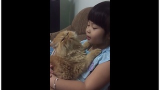 Little Girl Preciously Sings To Her Defiant Kitty Cat