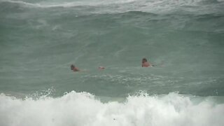 Heavy rain and active waves for surfers at Lake Worth Beach