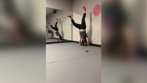 "A Girl Tries to Do A Handstand, But Falls Back Down"