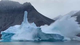 Photographers film iceberg falling apart