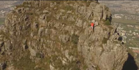 Drone footage of athlete running across Table Mountain ridge