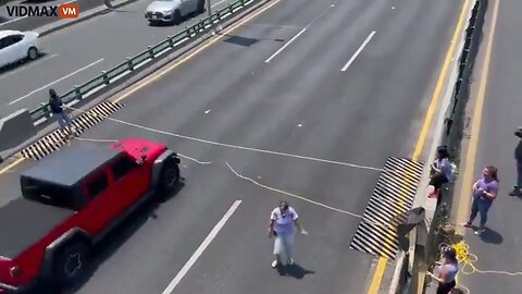 Low-IQ Protester Trying To Block A Highway With A Rope Gets Some Painful Karma