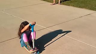 Two Kids Crash Riding A Bike And A Scooter