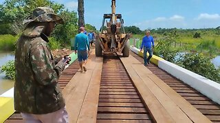 Backhoe working on the top of a wood bridge 😱