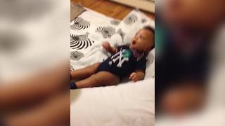 Baby Boy Shakes His Hands And Feet While His Mom Shakes A Rattle Toy