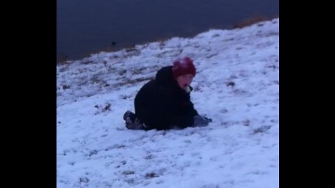 Carson throwing a Snowball Into a Lake