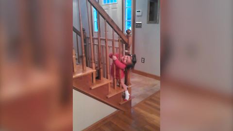 "Little Girl Squeezes Between Staircase Posts To Get Past Baby Proof Gate"