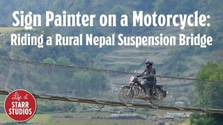Riding Across a Suspension Bridge in Nepal on a Motorcycle