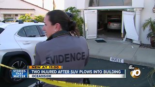 Two injured after SUV plows into building